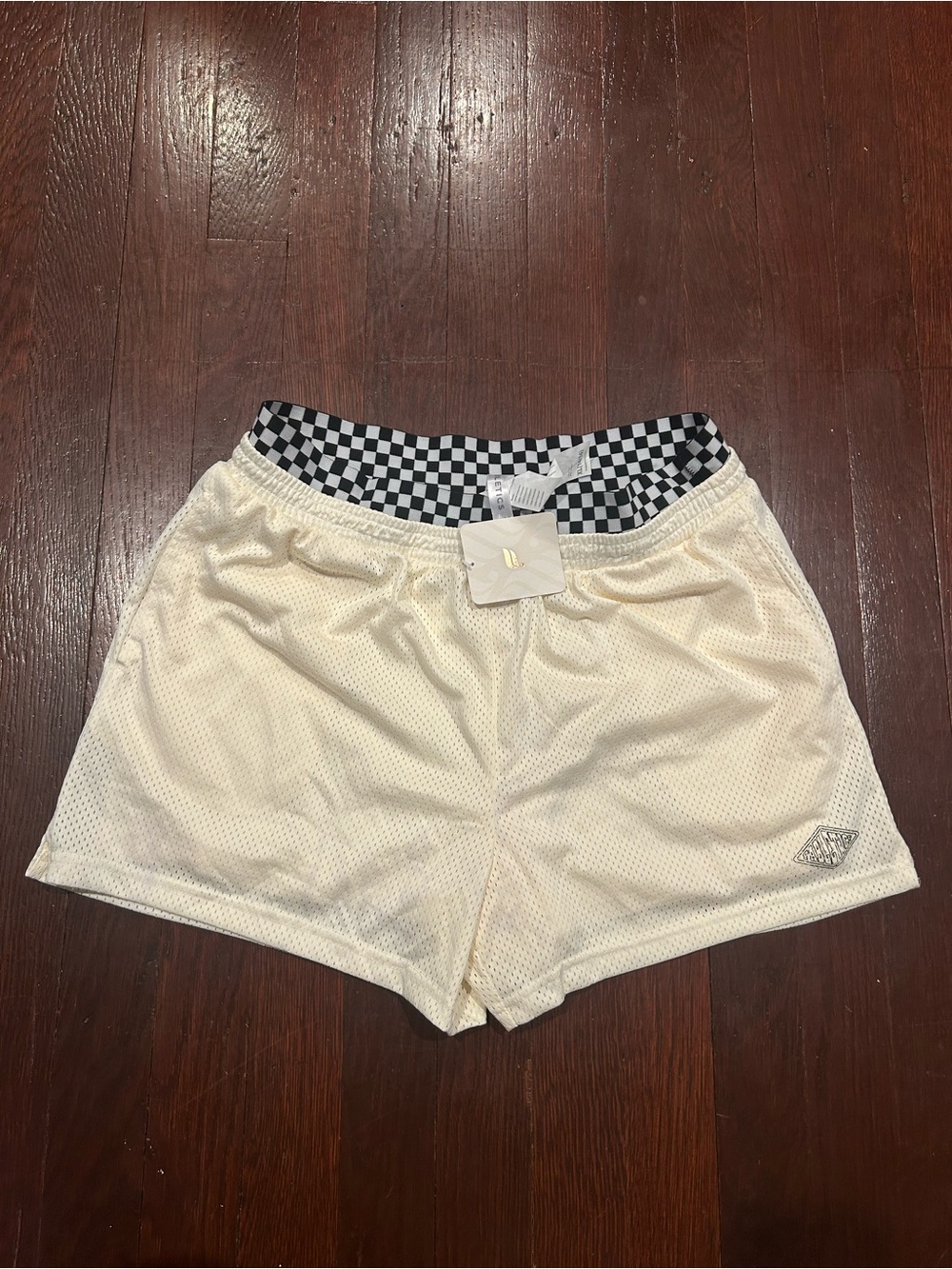 Fabletics Cream Athletic Shorts with Black-and-White Checker Waist